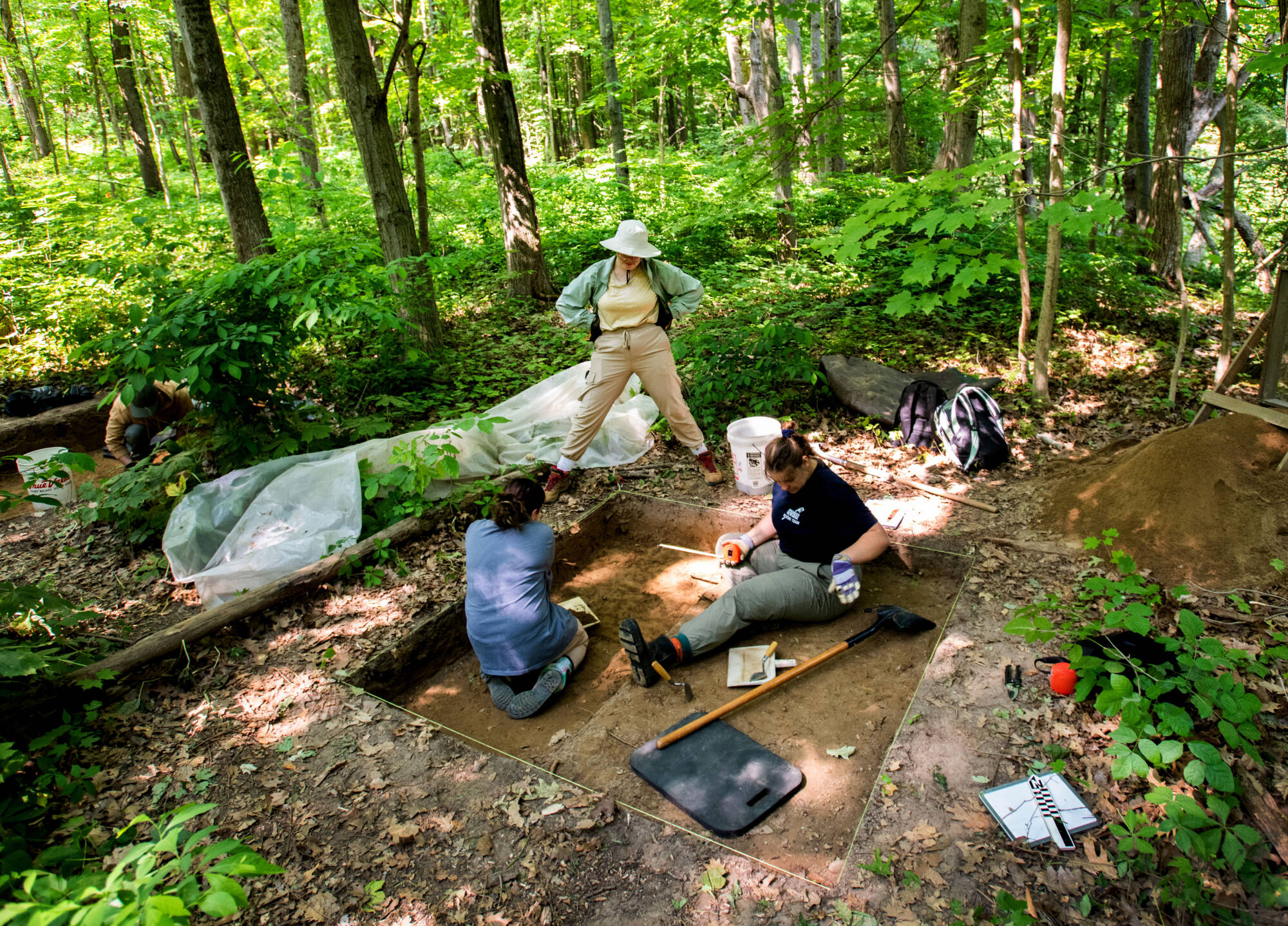 Arlo Van Conant, center, watches as two fellow students work on an archeology dig for Steven Dorland’s anthropology 307 class.(Photo releases on file)